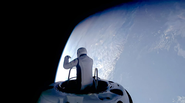 A video screenshot of Polaris Dawn mission commander Jared Isaacman egressing from the hatch of SpaceX's Crew Dragon Resilience capsule during a spacewalk...on September 12, 2024