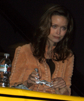 SUMMER GLAU poses with a TERMINATOR action figure